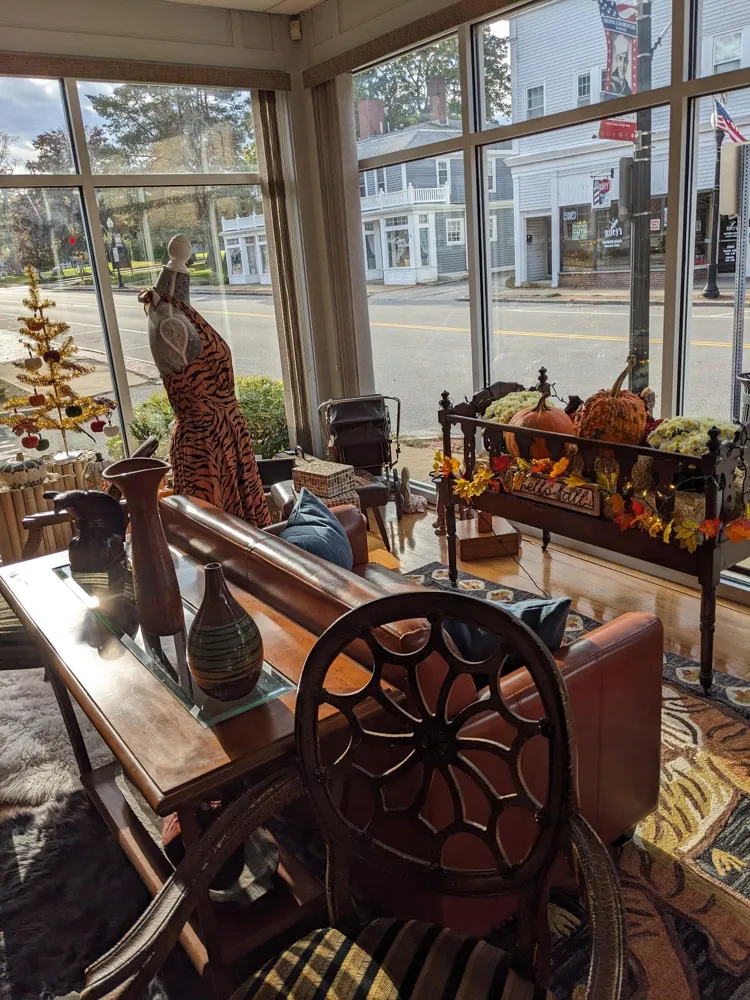 Fall display of mums and pumpkins on a carved bench