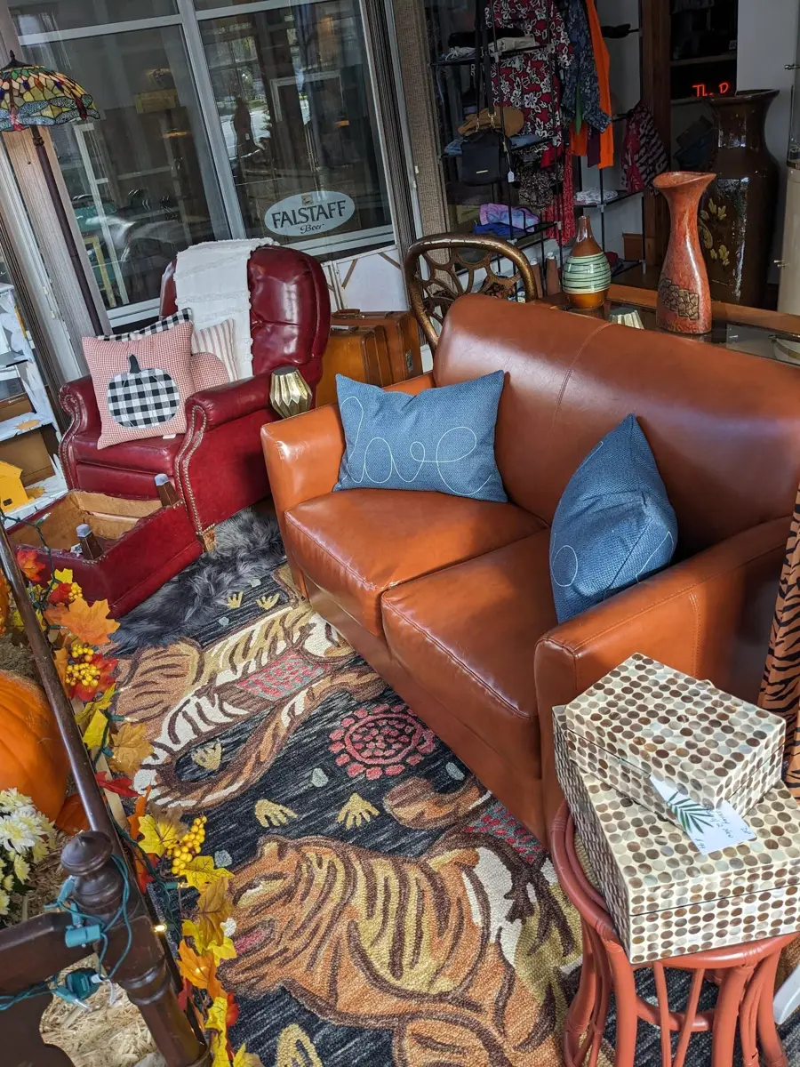 Leather sofa on a tiger-pattern rug inside The Rustic Rhino